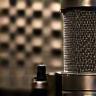Microphone in a recording booth representing music recording services.